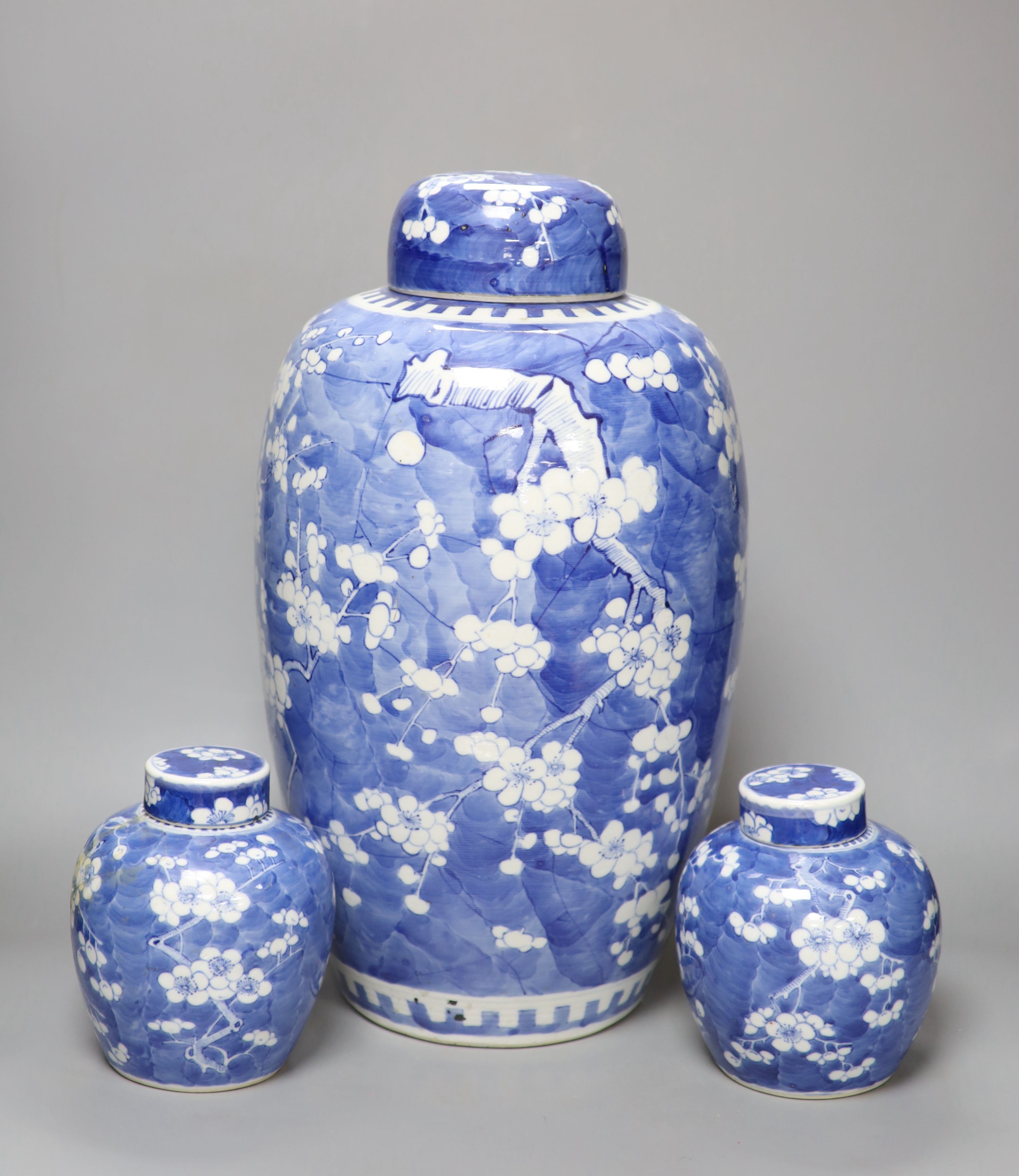 A tall 19th century Chinese blue and white lidded vase and a pair of lidded ginger jars, tallest 45cm